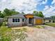 Exterior image of a new single-story home under construction with gray walls and unfinished landscaping at 5352 Lowell Ave, Spring Hill, FL 34609
