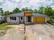 Exterior image of a new single-story home under construction with gray walls and unfinished landscaping at 5352 Lowell Ave, Spring Hill, FL 34609