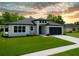 Beautiful single-story home with a modern design, lush green lawn, and a convenient two-car garage at 5352 Lowell Ave, Spring Hill, FL 34609
