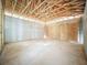 Unfinished garage with a concrete block wall and exposed rafter at 5352 Lowell Ave, Spring Hill, FL 34609