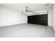 Modern garage with a black garage door and grey floor at 5352 Lowell Ave, Spring Hill, FL 34609