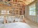 Open-concept unfinished living room with wood framing, concrete block walls, and lots of windows at 5352 Lowell Ave, Spring Hill, FL 34609