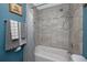 Bright bathroom featuring a bathtub with tiled walls and coordinated gray-and-white towels at 6084 71St N Ave, Pinellas Park, FL 33781