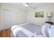 A well-lit bedroom featuring wood floors, a ceiling fan, and closet space at 6084 71St N Ave, Pinellas Park, FL 33781