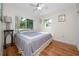 This cozy bedroom features hardwood floors, large windows, and ample natural light at 6084 71St N Ave, Pinellas Park, FL 33781