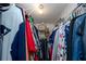 Walk in closet filled with clothing and storage boxes at 6084 71St N Ave, Pinellas Park, FL 33781