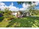 Charming single-story home with well-manicured lawn and colorful landscaping, complemented by stone accents at 6084 71St N Ave, Pinellas Park, FL 33781