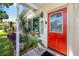 Inviting front entry with a vibrant red door and a charming 