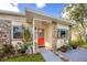 Charming home exterior showcasing stone accents and a vibrant red front door with a 
