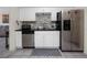 This well-equipped kitchen has white cabinets, stainless appliances, and modern backsplash at 6084 71St N Ave, Pinellas Park, FL 33781