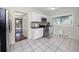 The well-lit kitchen is equipped with stainless steel appliances and white cabinetry at 6084 71St N Ave, Pinellas Park, FL 33781