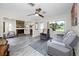 Comfortable living room with a ceiling fan, stone fireplace, and gray reclining sofa at 6084 71St N Ave, Pinellas Park, FL 33781