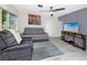 Comfortable living room with modern gray sofa and a TV at 6084 71St N Ave, Pinellas Park, FL 33781