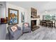 Cozy living area featuring a stone fireplace, stylish seating, and hardwood floors at 6084 71St N Ave, Pinellas Park, FL 33781