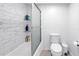 Shower/tub showcasing white tile surround and glass door, complete with shelving at 6236 93Rd N Ter # 3502, Pinellas Park, FL 33782
