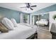 Bedroom with mirrored closet, ceiling fan, and balcony access for scenic views at 6236 93Rd N Ter # 3502, Pinellas Park, FL 33782