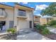 View of townhome with a balcony, garage, and tidy landscaping at 6236 93Rd N Ter # 3502, Pinellas Park, FL 33782