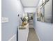 Light-filled hallway featuring coastal decor and access to staircase, with a beachy, inviting aesthetic at 6236 93Rd N Ter # 3502, Pinellas Park, FL 33782