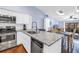 Bright kitchen with stainless steel appliances, white cabinets, and stone countertops at 6236 93Rd N Ter # 3502, Pinellas Park, FL 33782