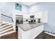 Modern kitchen with stainless steel appliances, white cabinets, light countertops, and a sunlit atmosphere at 6236 93Rd N Ter # 3502, Pinellas Park, FL 33782