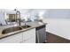 The kitchen features a stainless steel sink and granite countertops, with an open view to the dining area at 6236 93Rd N Ter # 3502, Pinellas Park, FL 33782