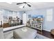 This open living room features a skylight, television, plush seating, and kitchen with modern appliances at 6236 93Rd N Ter # 3502, Pinellas Park, FL 33782