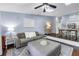 Comfortable living room showcases an ottoman, soft sofa, stylish lamps, and an open view of the kitchen and dining area at 6236 93Rd N Ter # 3502, Pinellas Park, FL 33782