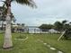 Lush backyard featuring mature trees, expansive lawn, waterfront access, and peaceful surroundings at 6711 Arroyo Dr, New Port Richey, FL 34652