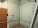 Unfinished basement utility access and storage room with exposed piping and electrical at 6711 Arroyo Dr, New Port Richey, FL 34652