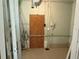 Unfinished basement utility access and storage room with a blocked doorway and utility connections at 6711 Arroyo Dr, New Port Richey, FL 34652