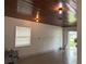 Garage featuring tile floors, fresh white paint and view of backyard at 6711 Arroyo Dr, New Port Richey, FL 34652