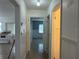 Hallway with paneled walls leading to the kitchen and another room at 6711 Arroyo Dr, New Port Richey, FL 34652