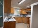 Kitchen featuring granite countertops, wood cabinets, stainless vent hood at 6711 Arroyo Dr, New Port Richey, FL 34652