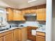 Kitchen featuring granite countertops, wood cabinets, stainless vent hood at 6711 Arroyo Dr, New Port Richey, FL 34652