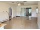 Spacious living area featuring fresh white paint, tile floors, and a sliding glass door to the backyard at 6711 Arroyo Dr, New Port Richey, FL 34652