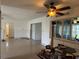 Open living area with tile floors, white walls, ceiling fan and view of the sunroom at 6711 Arroyo Dr, New Port Richey, FL 34652