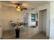 Open-concept living area featuring tile floors, white walls, and view of the kitchen area at 6711 Arroyo Dr, New Port Richey, FL 34652