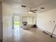 Bright living area featuring fresh white paint, tile floors, and a window overlooking the front yard at 6711 Arroyo Dr, New Port Richey, FL 34652