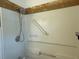 Shower with a showerhead and grab bar, featuring a white surround at 6711 Arroyo Dr, New Port Richey, FL 34652