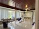 Open sunroom featuring tile flooring, ceiling fan, and a hammock at 6711 Arroyo Dr, New Port Richey, FL 34652
