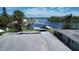 Aerial perspective of waterfront property featuring boat docks, lush greenery, and access to serene waters at 6711 Arroyo Dr, New Port Richey, FL 34652
