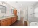 Bathroom featuring double vanity, garden tub and a walk-in shower at 7333 S Trask St, Tampa, FL 33616