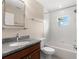 Bathroom showcasing a vanity with a granite countertop and a shower-tub combination at 7333 S Trask St, Tampa, FL 33616