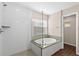 Bathroom featuring shower, soaking tub, and granite countertops at 7333 S Trask St, Tampa, FL 33616