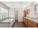 Bathroom with double vanity, garden tub and walk in shower at 7333 S Trask St, Tampa, FL 33616
