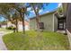 Home exterior showing the side of the house, landscaping and a garage at 7333 S Trask St, Tampa, FL 33616