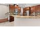 Kitchen featuring a breakfast bar, stainless appliances, and wood cabinets at 7333 S Trask St, Tampa, FL 33616