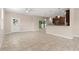 Large living space with tile floors, transitioning into an open kitchen with a breakfast bar at 7333 S Trask St, Tampa, FL 33616