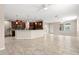 Bright, open-concept living area with tiled floors, seamlessly connected to a modern kitchen at 7333 S Trask St, Tampa, FL 33616