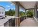 Spacious front porch with stone accents and wrought iron railings, offering a charming outdoor space at 7333 S Trask St, Tampa, FL 33616